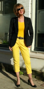 combine black blazer with yellow jumper jeans and yellow top
