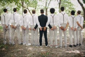 all groomsmen backing the photographer with the groom at the center - offbeatbride