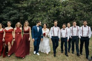 bridal train and groomsmen walking down with couples at the center - sweetsail com br