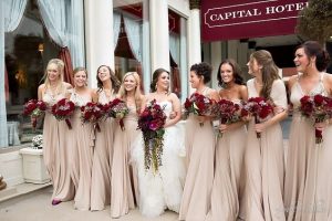 bridal train walking into the party hall each with flower and the bride at the center - colorbridesmaid