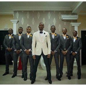 groom on a different suit colour all lined up in v shape - voxlocalis net