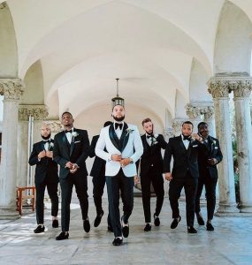 groomsmen on suit walking majestically as camera man takes the shot - youandbigday