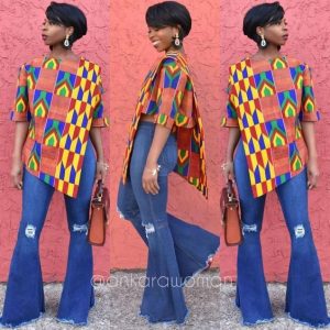 lady slaying with a combination of kente blouse with jeans trousers - ykmmedia