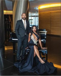 the lady sits like a queen in hot gown while the man stands like a body guard - nairaland