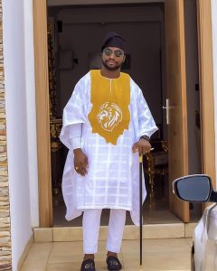 white ankara agbada with gold lions head embroidery and black cap for men - couturecrib