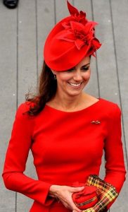 classy red fascinator hat with a matching purse