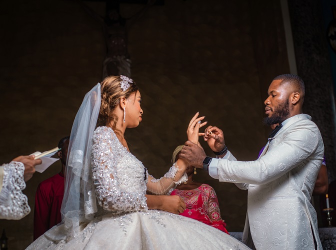 asastan white wedding photo styles 12 - groom putting the wedding ring into the brides finger