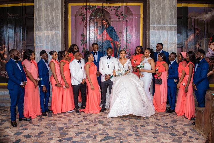 asastan white wedding photo styles 31 - another shot of couple, men on suit and bridal train (aso ebi)